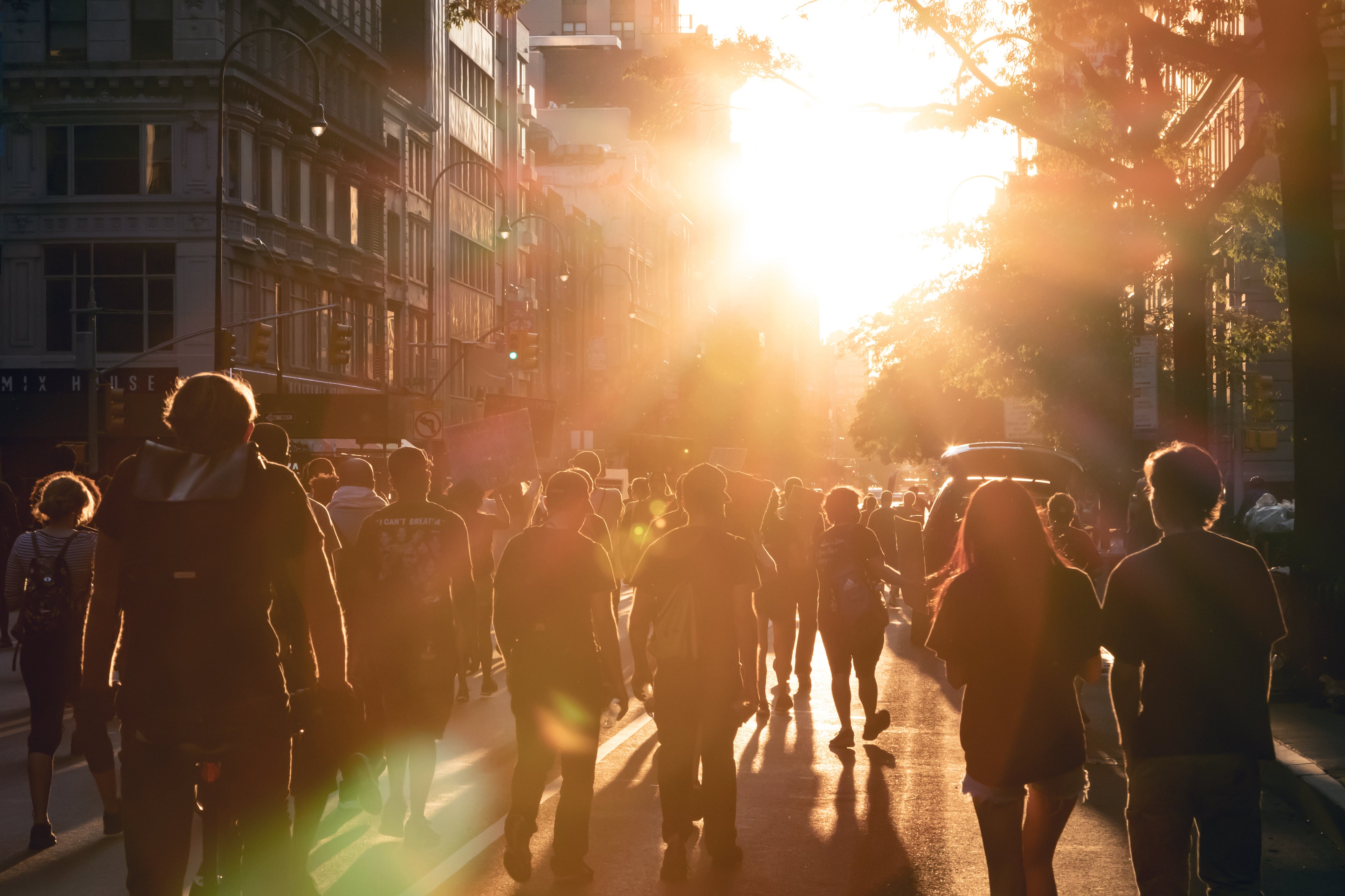domestic violence statistics, people walking in the street as the sun sets ahead of them