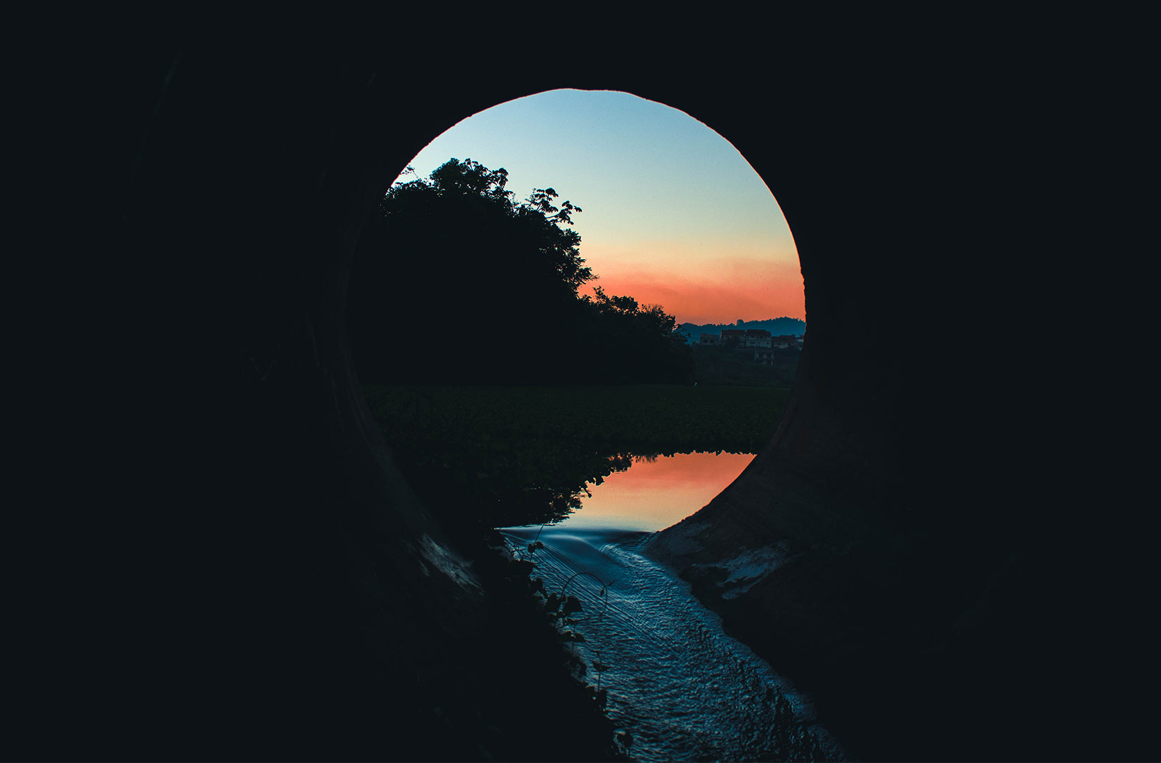 eap provider, waterway tunnel opening looking at trees and sunset in the distance