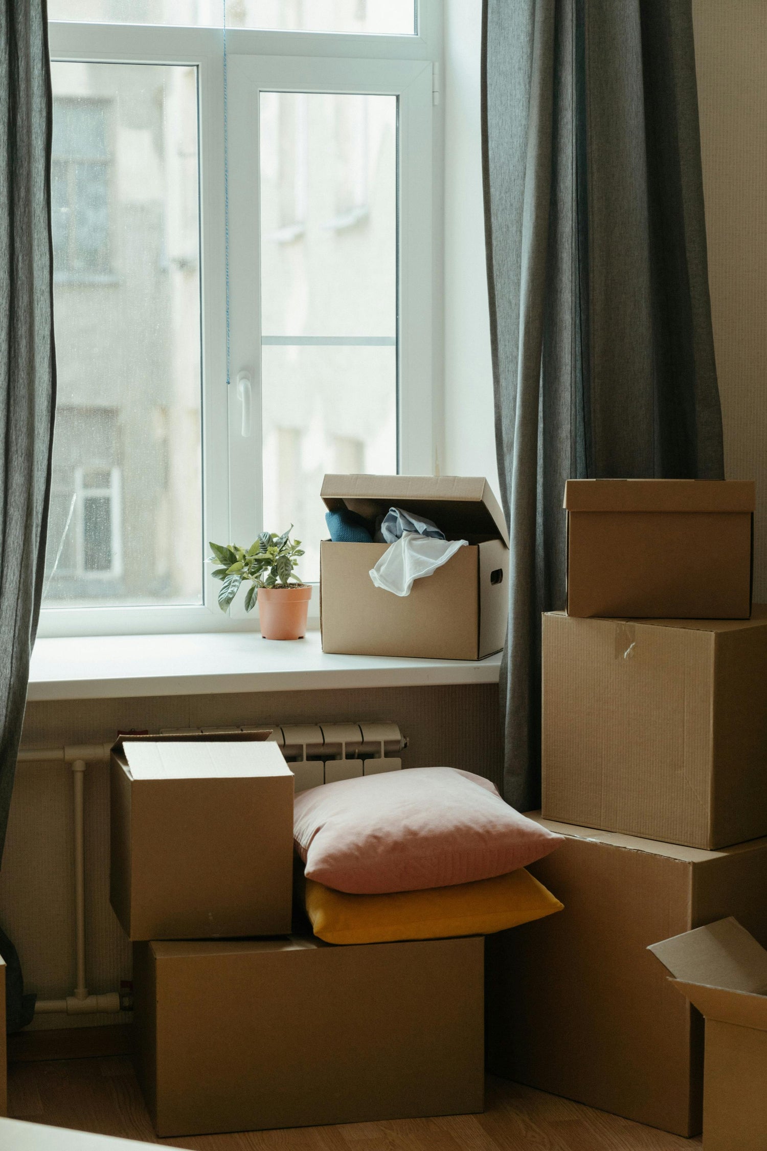 moving boxes in a house preparing for domestic violence relocation assistance