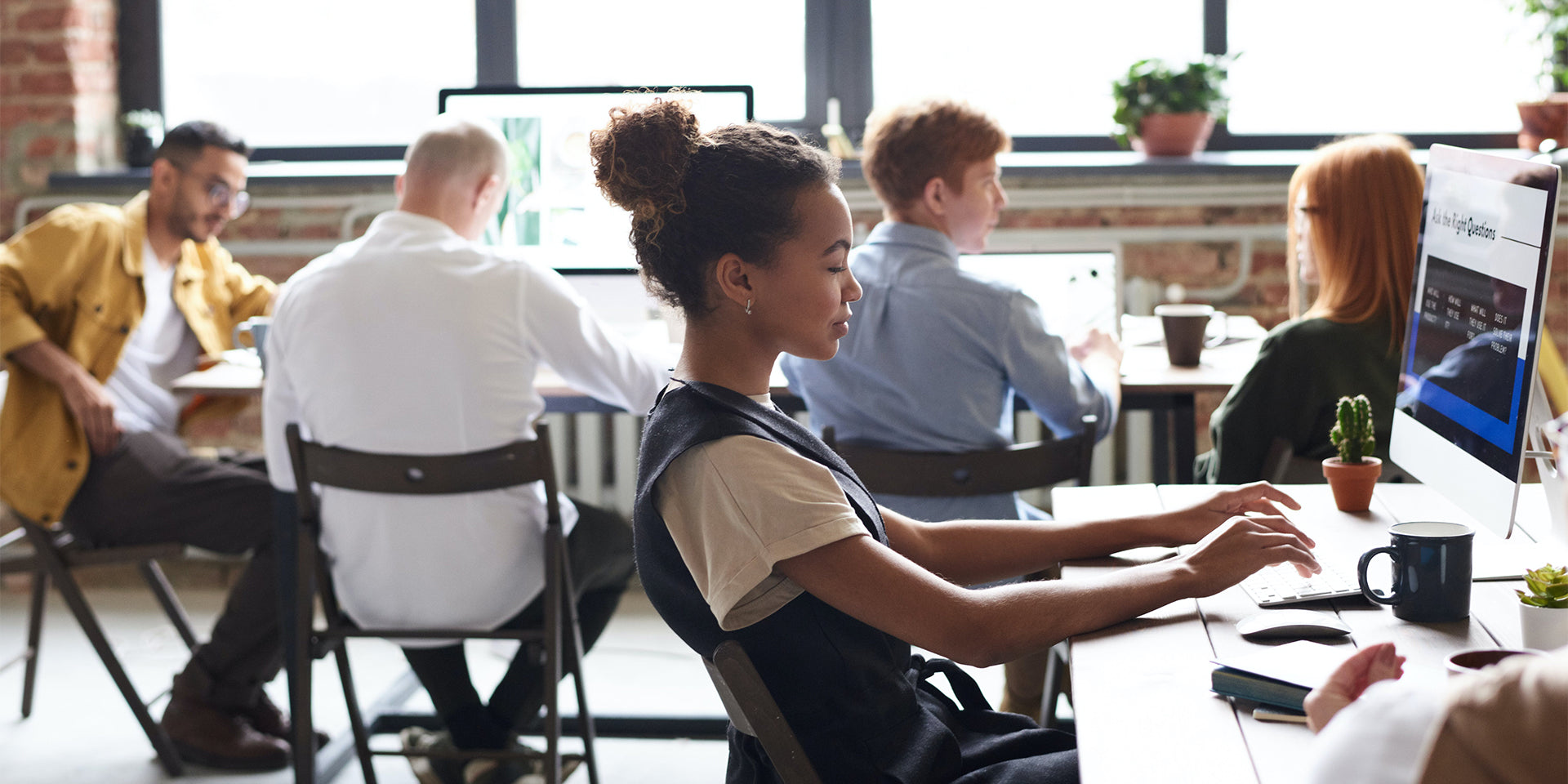 woman accessing employee and family services at her computer in the workplace