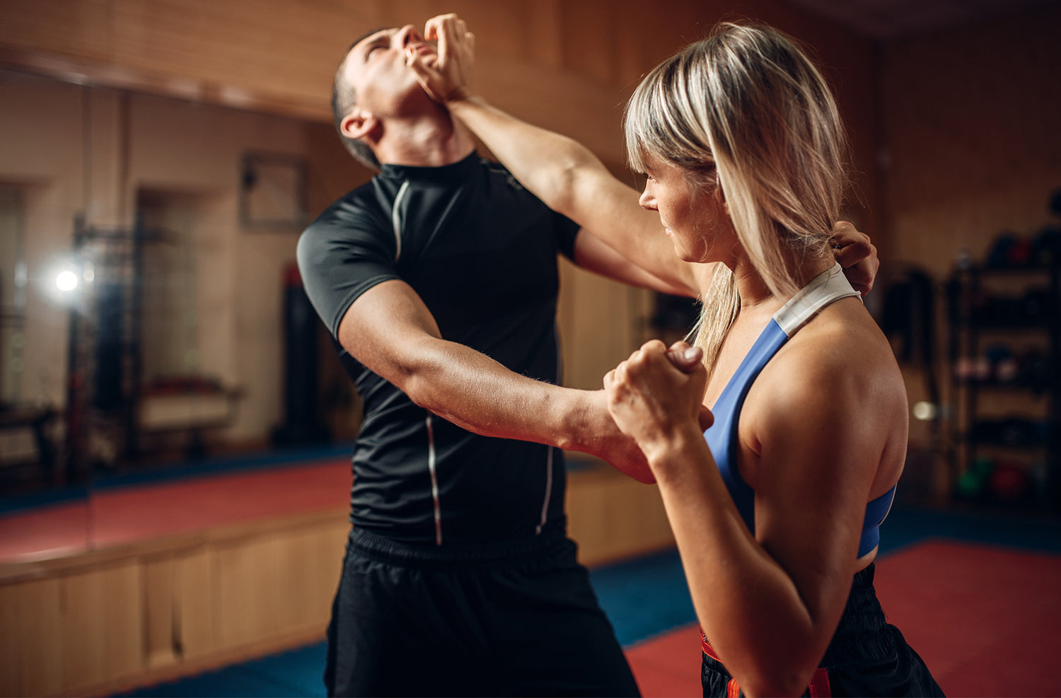 A woman striking a man in self defense classes